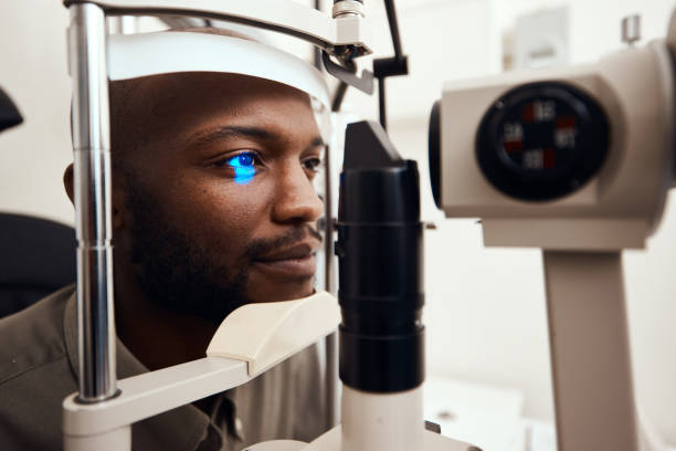 Shot of a young man getting his eye’s examined with a slit lamp Eye's Land Eye Clinic